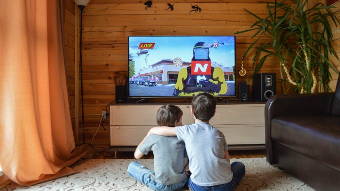 faceless little boys entertaining with tv at home