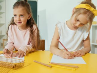 a young girls writing on the paper