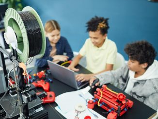 group of focused children using laptop