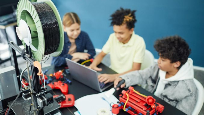 group of focused children using laptop
